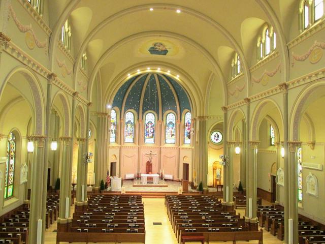 inside of a church with tall arches