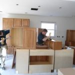 Man working on cabinets