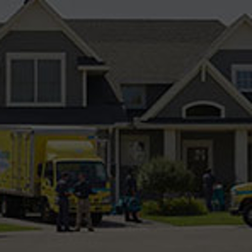 servicemaster team in front of residential house