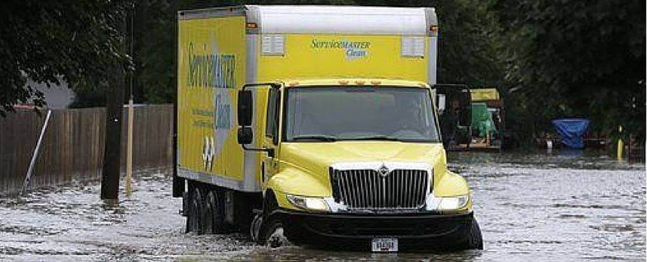 ServiceMaster Ctruck driving through flooded street