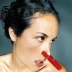 Woman with a clip on her nose