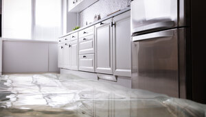 Flooded kitchen floor needing emergency water cleanup services in New London