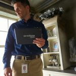 Man holding a ServiceMaster tablet