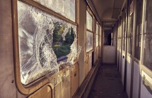 broken window in vandalized house